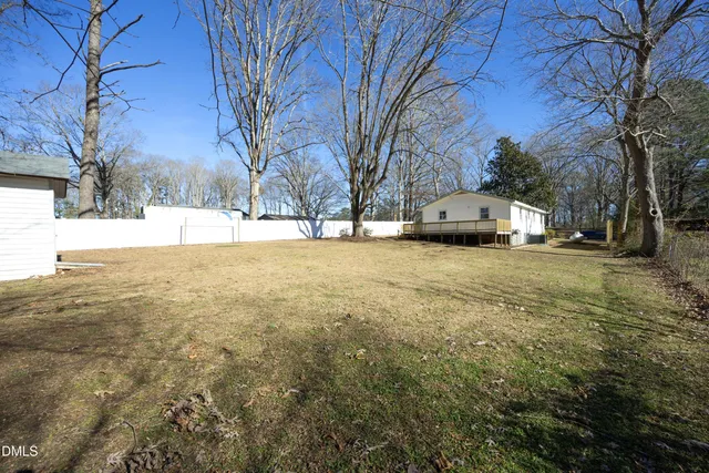 a view of large tree with a wooden fence