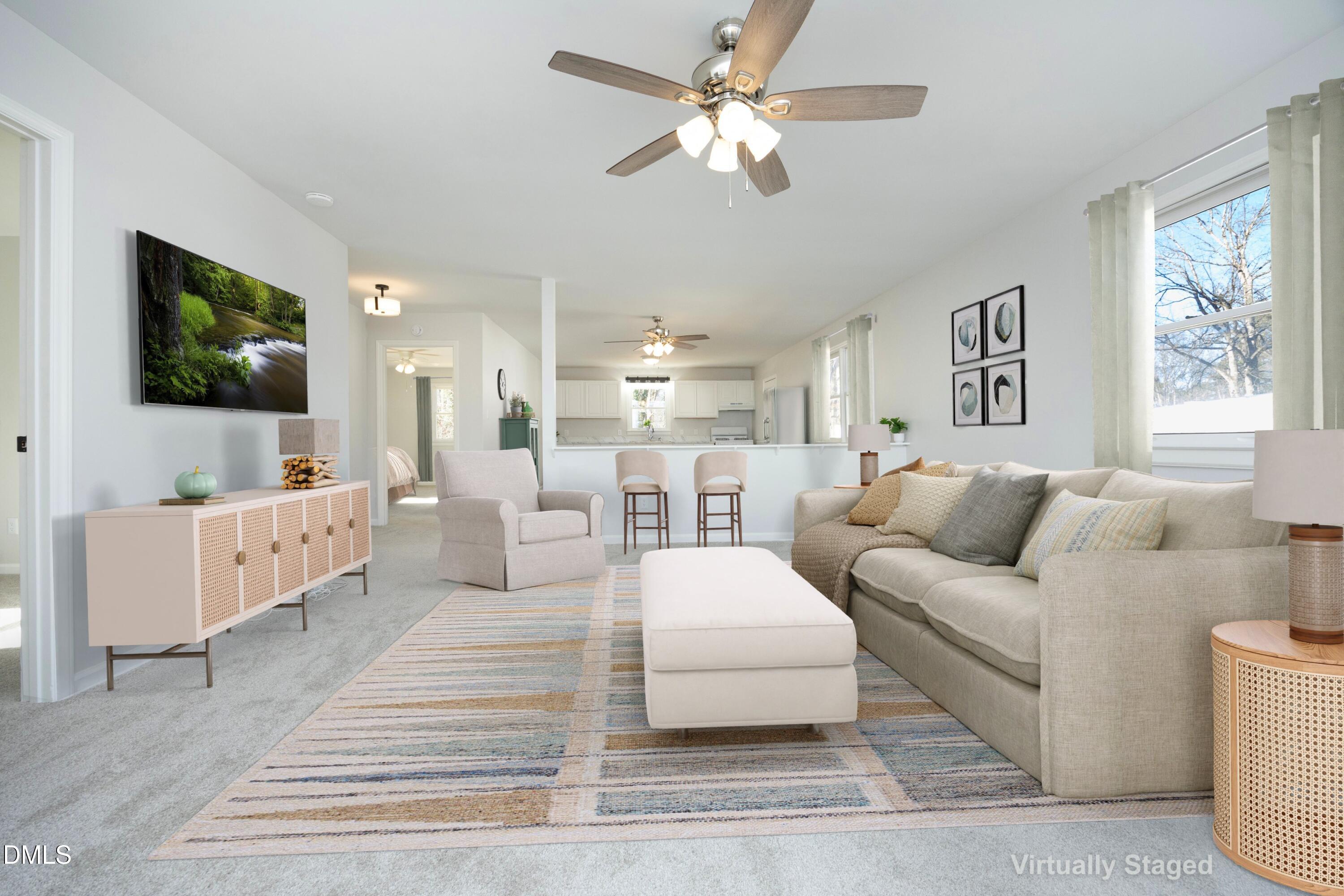 5108 Old Valley Street Raleigh, NC 27603 - Photo 9 of 37 a living room with furniture a flat screen tv and a chandelier