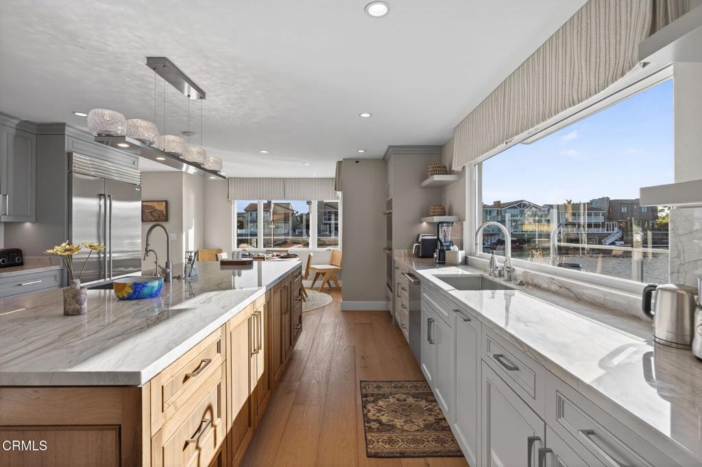 2131 Ravoli Drive Oxnard, CA 93035 - Photo 27 of 53 a large kitchen with kitchen island a large window a sink and stainless steel appliances
