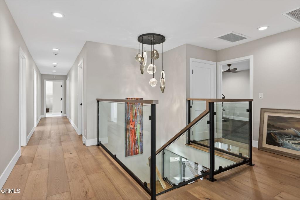 2131 Ravoli Drive Oxnard, CA 93035 - Photo 32 of 53 a view of a hallway with wooden floor and staircase