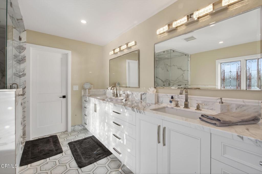 2131 Ravoli Drive Oxnard, CA 93035 - Photo 36 of 53 a spacious bathroom with double vanity and a mirror