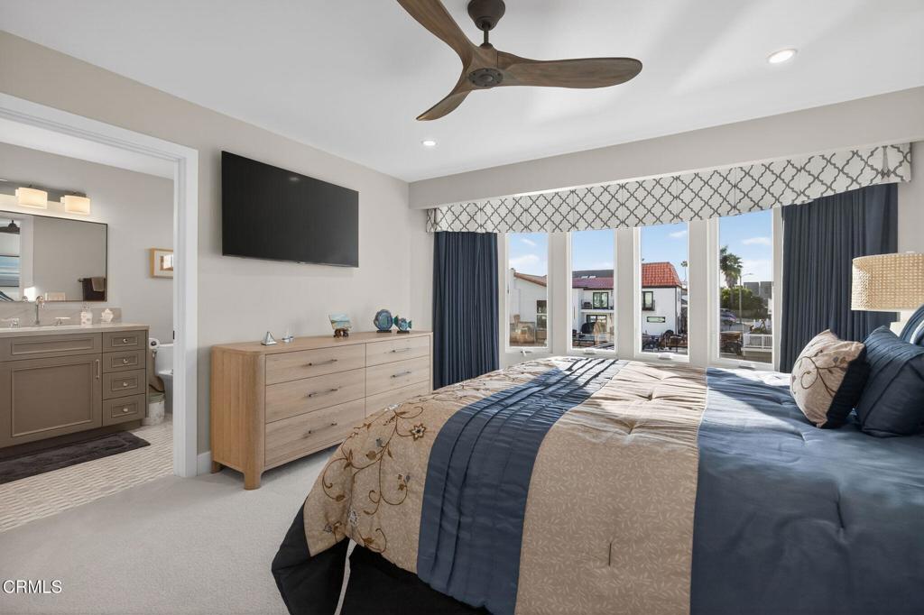 2131 Ravoli Drive Oxnard, CA 93035 - Photo 41 of 53 a bedroom with a large bed and a flat tv screen on dresser