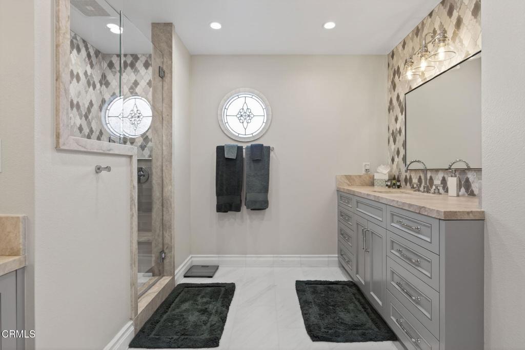 2131 Ravoli Drive Oxnard, CA 93035 - Photo 44 of 53 a bathroom with a sink a light fixture and a mirror