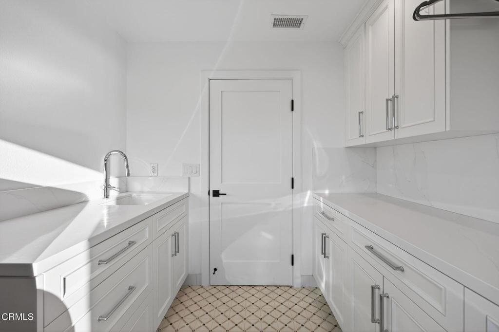 2131 Ravoli Drive Oxnard, CA 93035 - Photo 47 of 53 a bathroom with a sink and a mirror