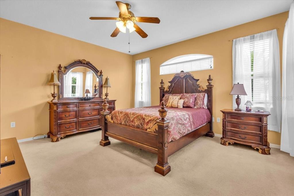 15688 Lemon Fish Drive Lakewood Ranch, FL 34202 - Photo 13 of 18 a bedroom with a bed and a chandelier