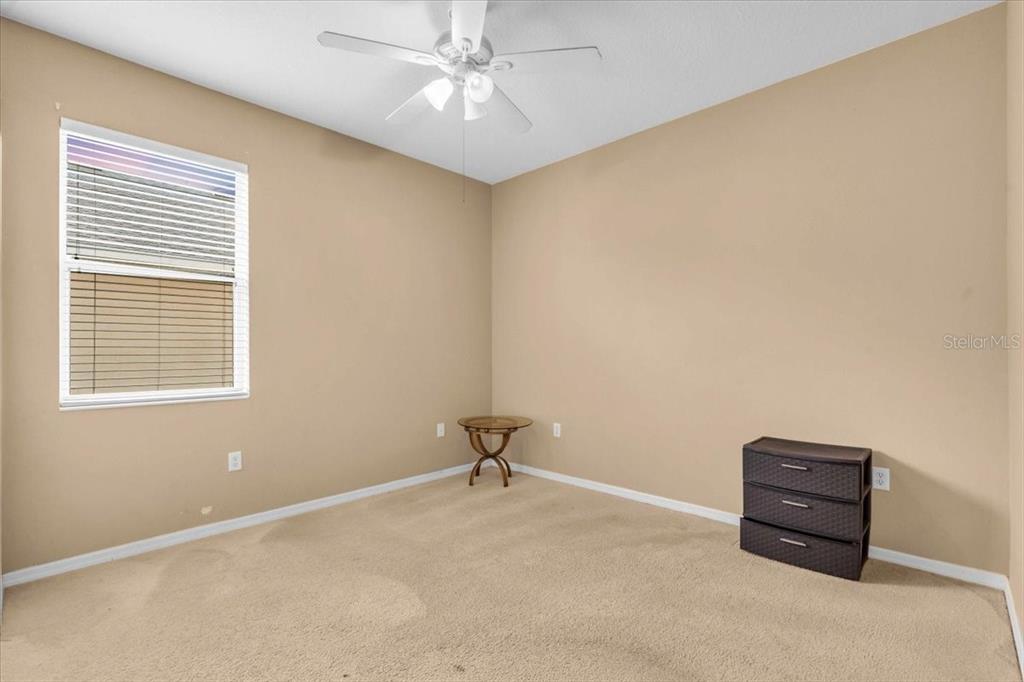 15688 Lemon Fish Drive Lakewood Ranch, FL 34202 - Photo 15 of 18 a room with a ceiling fan and a window