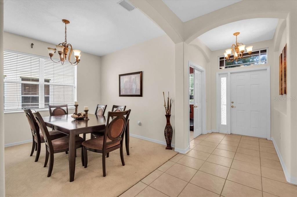 15688 Lemon Fish Drive Lakewood Ranch, FL 34202 - Photo 5 of 18 a view of a dining room with furniture and chandelier