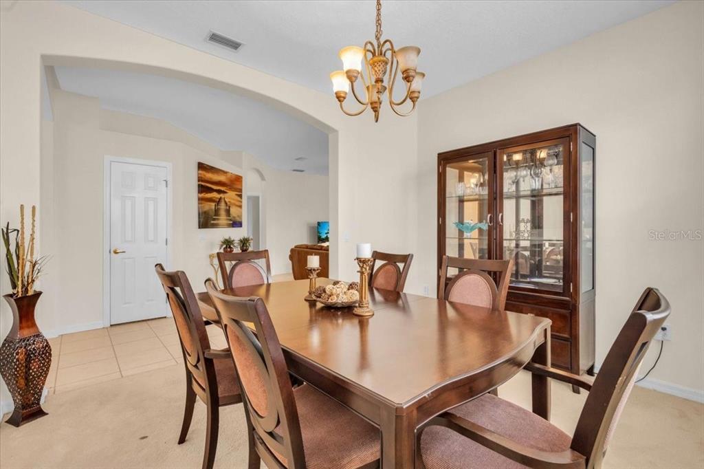 15688 Lemon Fish Drive Lakewood Ranch, FL 34202 - Photo 6 of 18 a view of a dining room with furniture and chandelier