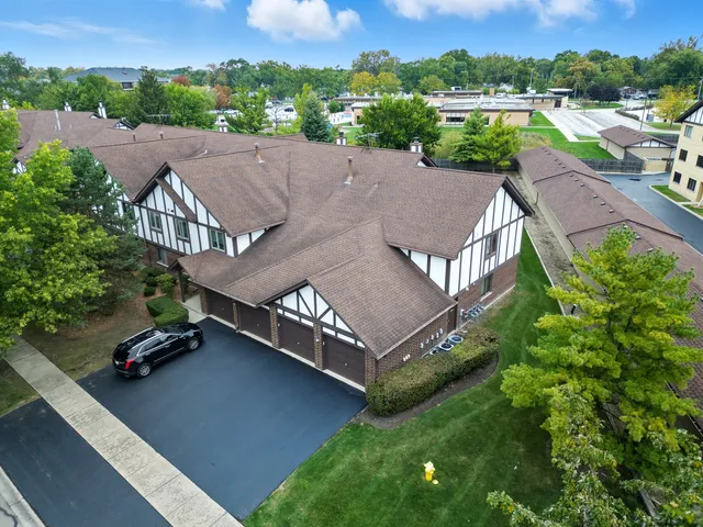an aerial view of multiple houses with a yard