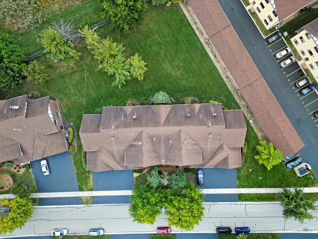 an aerial view of a house with a yard