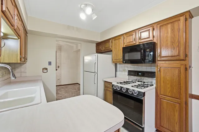 a kitchen with stainless steel appliances a refrigerator stove and microwave