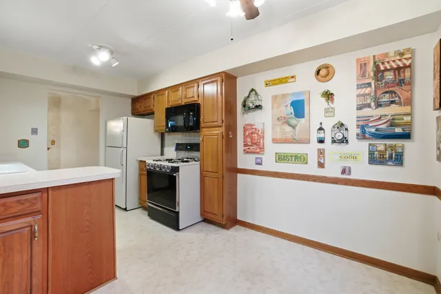 a large kitchen with stainless steel appliances granite countertop a stove and a sink