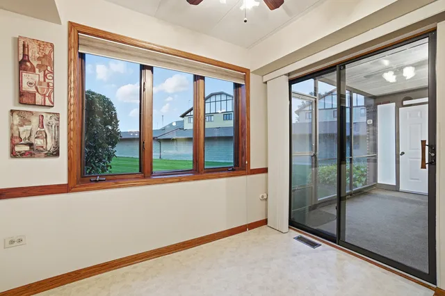 a view of a hallway with windows and chandelier