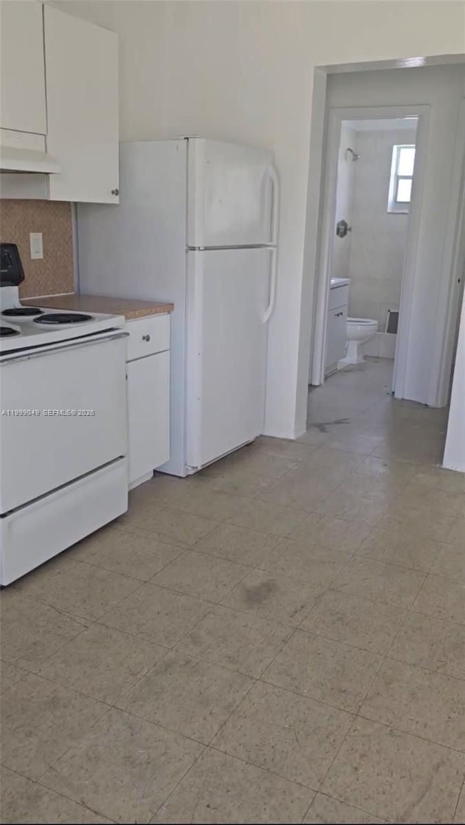 a view of a kitchen with cabinets