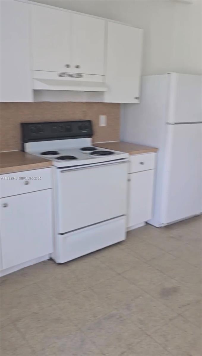 320 Southwest 11th Avenue, Unit 1 Homestead, FL 33030 - Photo 2 of 5 a stove top oven sitting inside of a kitchen