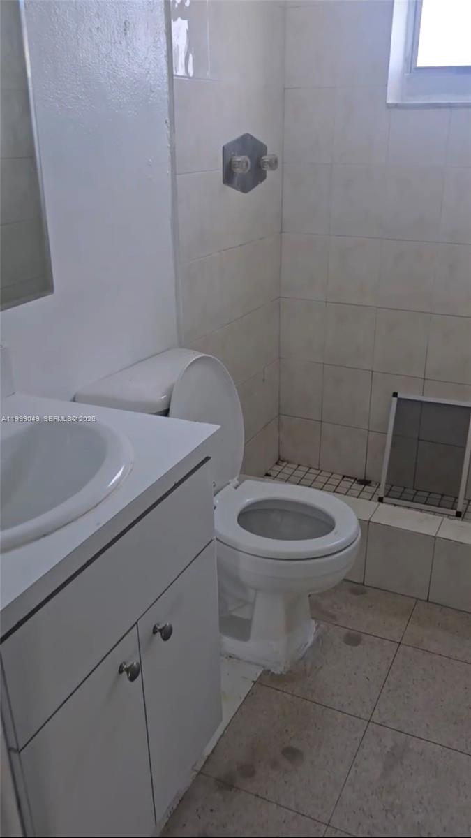 320 Southwest 11th Avenue, Unit 1 Homestead, FL 33030 - Photo 4 of 5 a white toilet sitting next to a bathroom sink