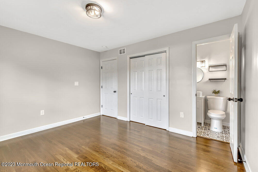 28 Maplecrest Drive Neptune Township, NJ 07753 - Photo 11 of 20 a view of a room with wooden floor and a bathroom