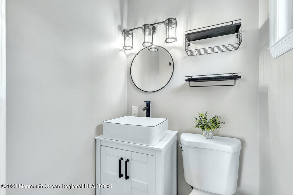 28 Maplecrest Drive Neptune Township, NJ 07753 - Photo 12 of 20 a bathroom with a toilet sink and mirror