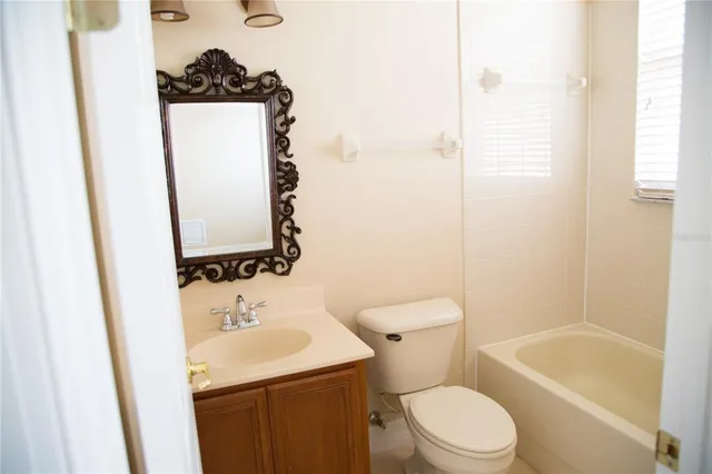 a bathroom with a double vanity sink mirror and bathtub