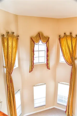 a view of a kitchen with a refrigerator and a stove top oven