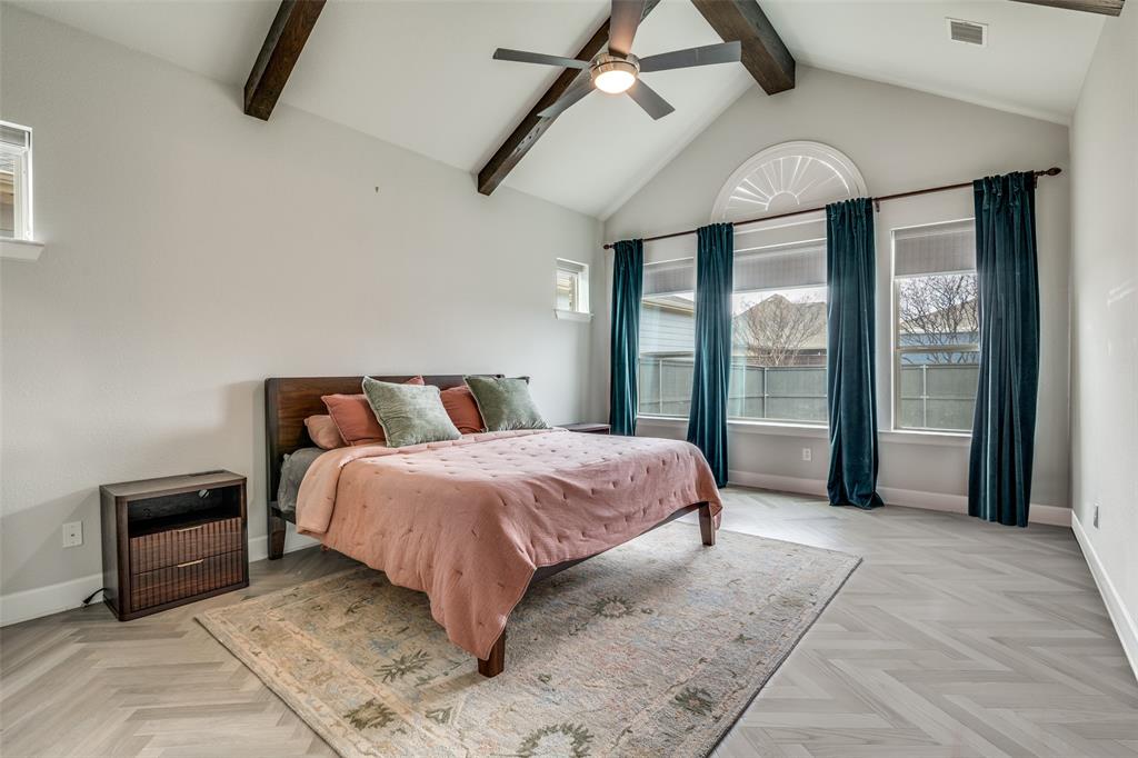 8917 Homestead Boulevard Rowlett, TX 75089 - Photo 17 of 40 a spacious bedroom with a bed and a chandelier