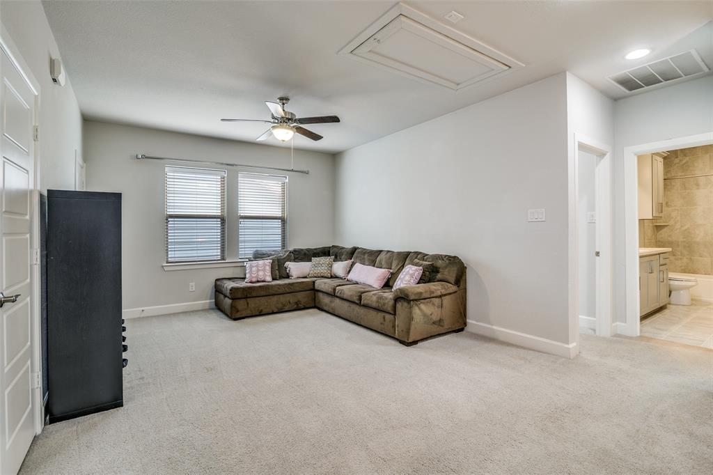 8917 Homestead Boulevard Rowlett, TX 75089 - Photo 24 of 40 a spacious bedroom with a bed and a couch