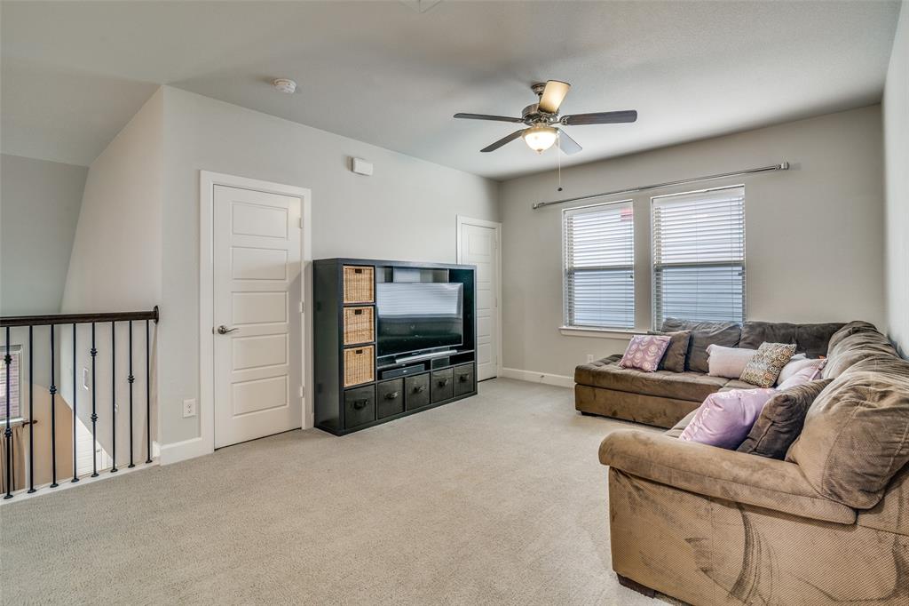 8917 Homestead Boulevard Rowlett, TX 75089 - Photo 25 of 40 a living room with furniture and a flat screen tv