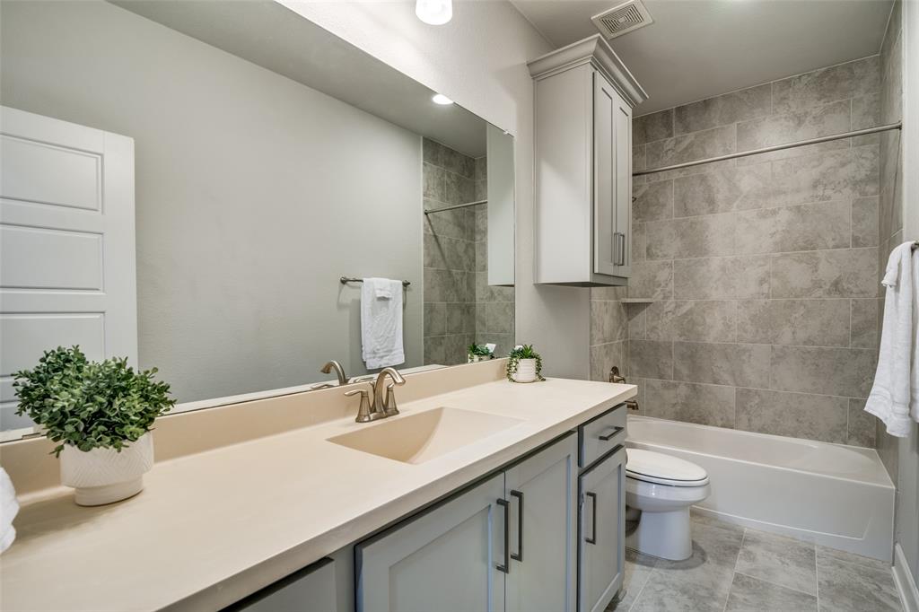 8917 Homestead Boulevard Rowlett, TX 75089 - Photo 27 of 40 a bathroom with a sink a toilet and shower
