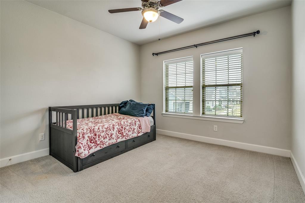 8917 Homestead Boulevard Rowlett, TX 75089 - Photo 28 of 40 a bed room with a bed and a chandelier
