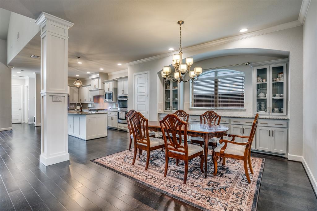 8917 Homestead Boulevard Rowlett, TX 75089 - Photo 3 of 40 a view of a dining room with furniture and wooden floor