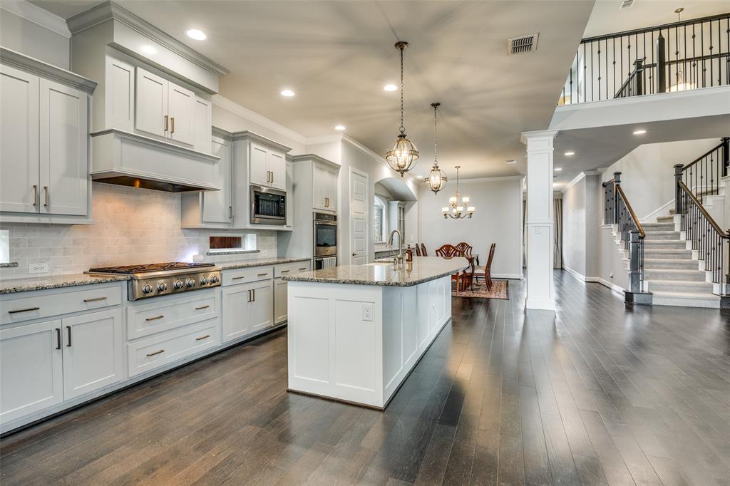 8917 Homestead Boulevard Rowlett, TX 75089 - Photo 4 of 40 a large white kitchen with lots of counter space a sink appliances and cabinets