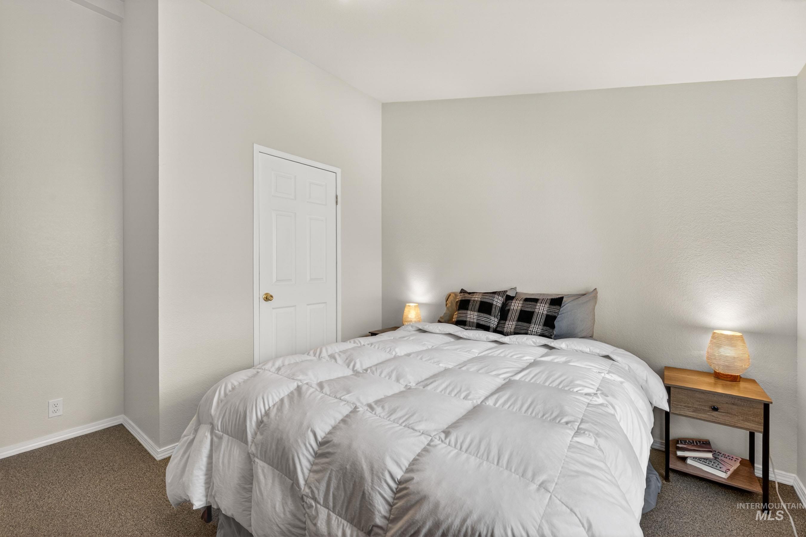 151 Cow Creek Road Lucile, ID 83542 - Photo 35 of 50 Carpeted bedroom featuring neutral wall tones and a paneled door with a brass knob