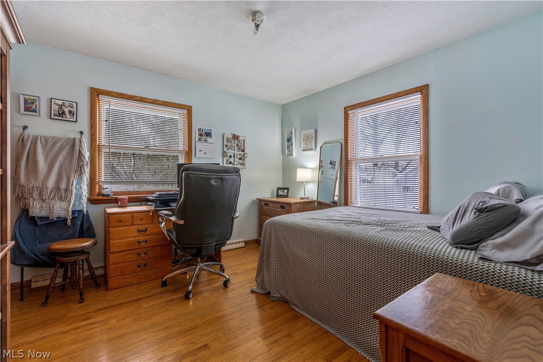 6775 Grove Road Clinton, OH 44216 - Photo 16 of 19 Bedroom featuring light wood-style flooring and a textured ceiling