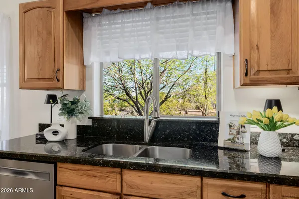 a kitchen with a table chairs microwave and cabinets