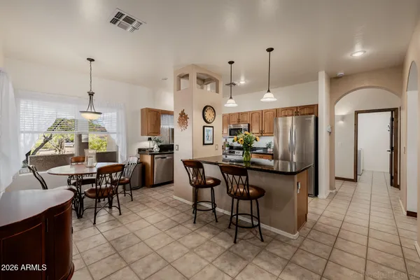 a spacious bedroom with a bed and a chandelier