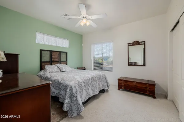 a view of a patio with table and chairs under an umbrella with wooden fence