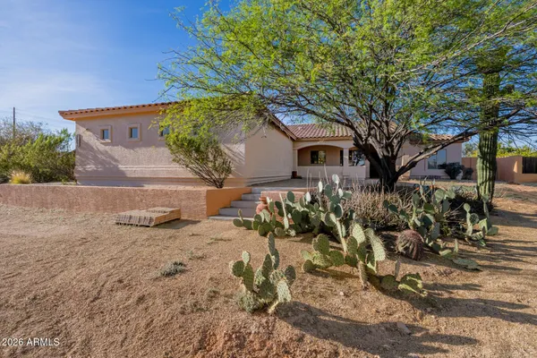 a kitchen with stainless steel appliances granite countertop a sink a stove a microwave a counter space and cabinets