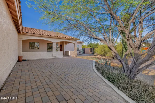 a kitchen with granite countertop a sink a stove and cabinets