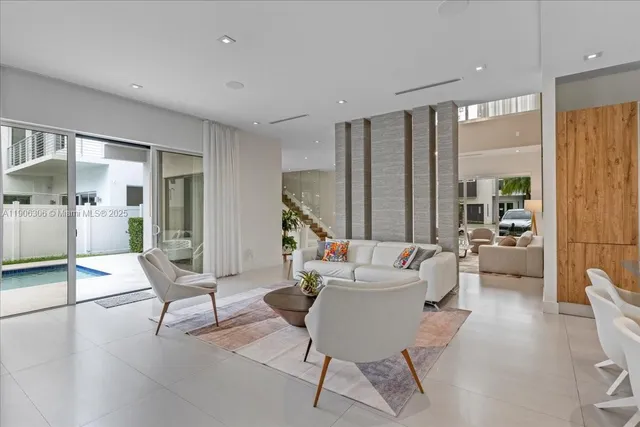 a kitchen with kitchen island granite countertop a sink stove and cabinets