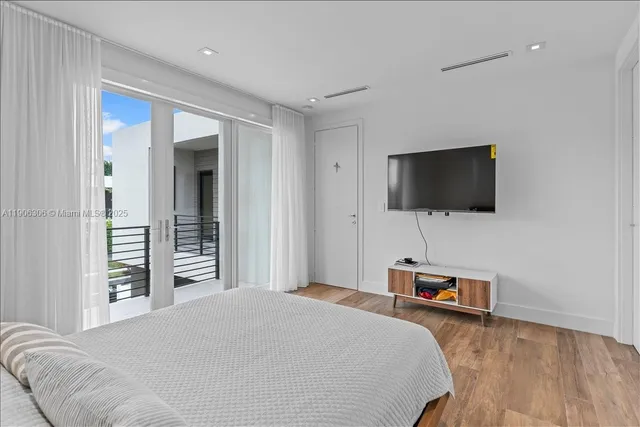 a bedroom with a bed and a couch