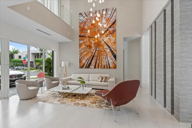 a living room filled with furniture and a large window