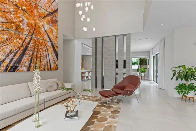 a living room with furniture and a floor to ceiling window