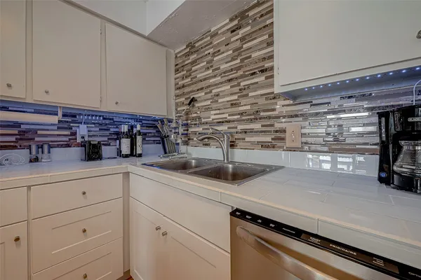 a kitchen with a sink and cabinets