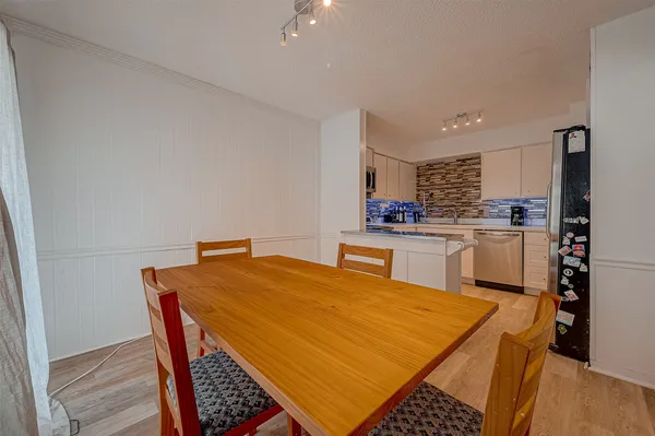 a kitchen with a sink a stove and chairs