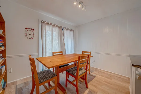 a dining room with a wooden table and chairs