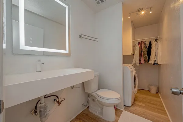 a bathroom with a sink a toilet and shower