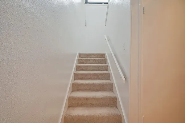 a view of staircase with white walls