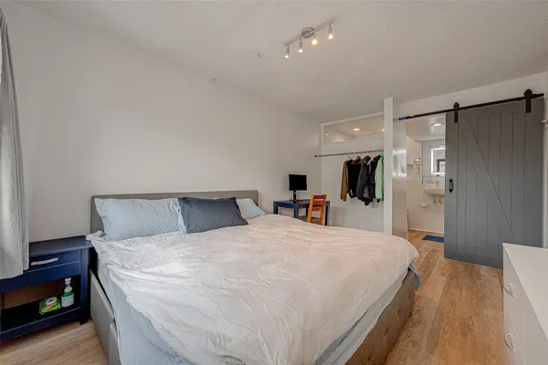 a bed room with a bed mirror and a night stand