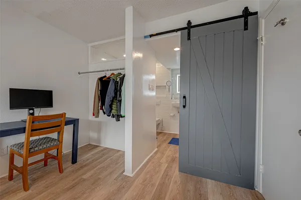 a view of a livingroom with furniture and wooden floor