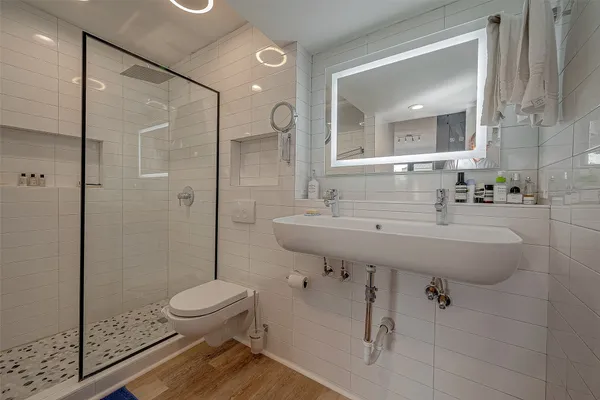 a bathroom with a sink toilet and shower